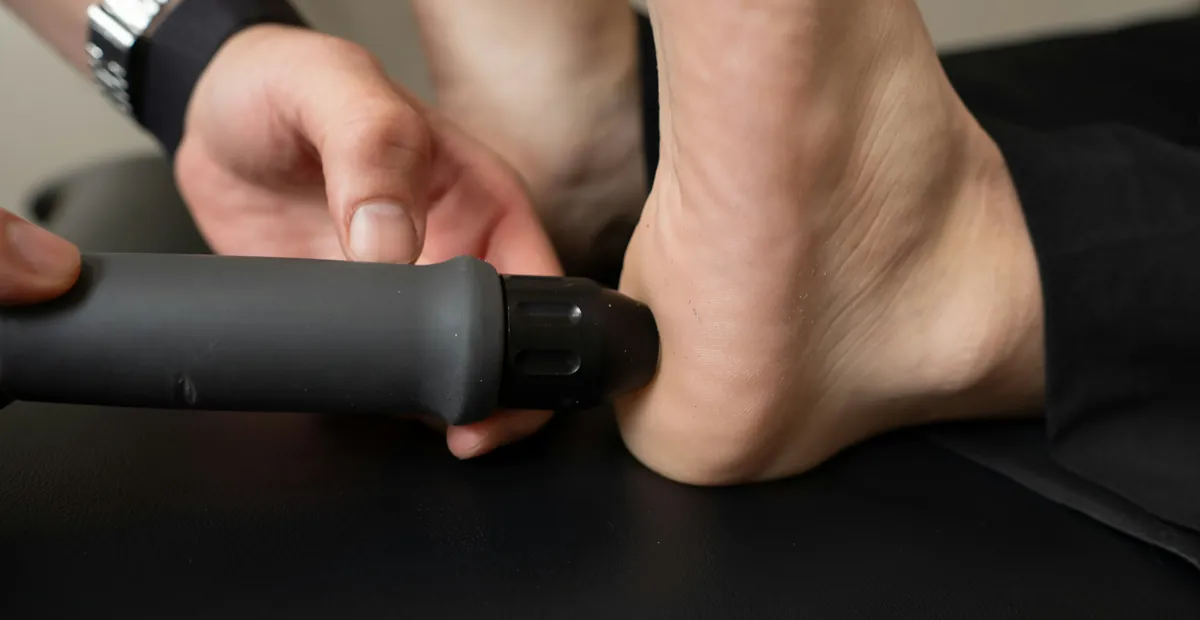 Shockwave therapy being applied to a patient's heel